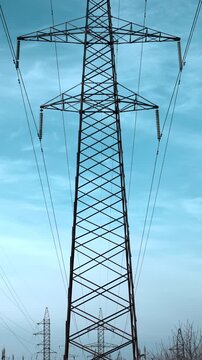 Tall Towers Stretch Across Sky, Metal Lattice Structures Stand Tall Beneath Expansive Blue Sky . Media