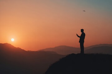 Fototapeta premium Breathtaking sunset view over mountains. Silhouette of a person standing on top, enjoying the tranquility.