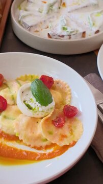 Homemade ravioli pasta italian cuisine hands cutting a piece. Dumpling filled cheese tortellini. High quality FullHD footage