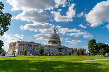 Obraz premium Historic Capitol by the national flag. Capitol dome as symbol of law. Washington monument architecture. Washington DC. US Senate. Federal government in the nation capital. USA symbol