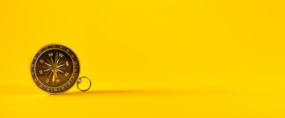 Golden compass on a yellow background © Artvibe