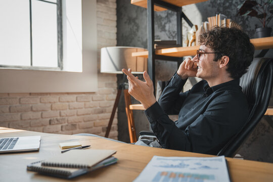 Office, businessman and talking with phone call for negotiation, funding discussion and smile. Career, male person and financial advisor with mobile for communication, offer and networking to contact