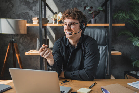 Happy, laptop and young man with microphone on video call for customer enquiry, virtual meeting or campaign update. Agency, specialist and clients support project management or planning