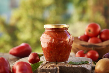 Tomato and sweet pepper relish or chutney in a glass jar