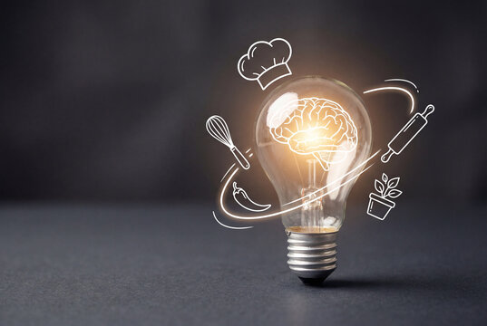 Light bulb with glowing brain and white cooking icons floating on dark background
