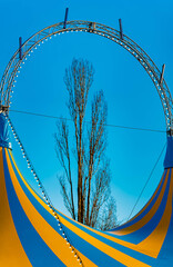 Fototapeta premium Winter landscape on a sunny day with a blue and yellow circus tent at Straubing, Bogen, Bavaria, Germany