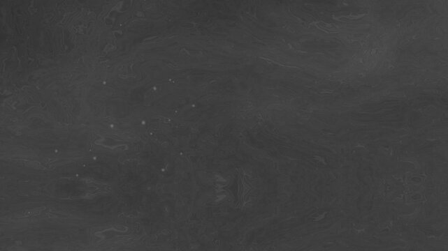 Dark grey textured surface resembling a chalkboard or slate with subtle marks and dust.