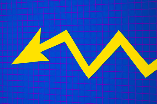 Arrows cut out of colored paper imitating a graphic chart of increase or decrease.
