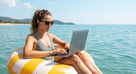 Girl in swimsuit with laptop floating on the sea in inflatable beach circle. Remote work during summer vacation at sea. Opportunity to work anywhere. Young freelancer woman. Free space on the right.