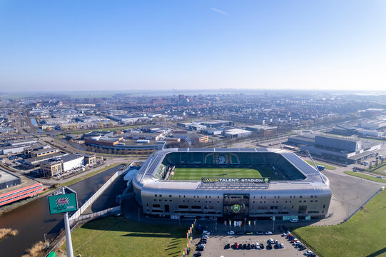 Aerial of ADO Den Haag football stadium soccer stadion field in The Hague with city skyline in the background. Dutch National championship premier league venue seen from above in The Netherlands