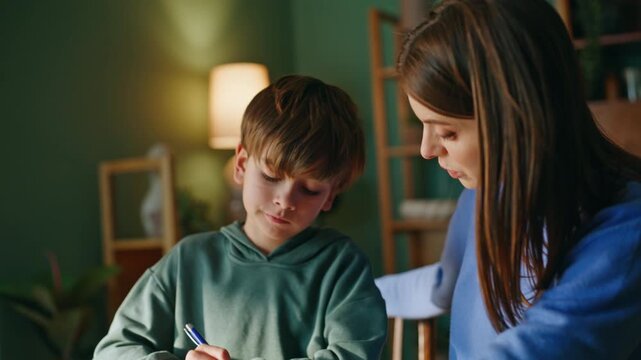 Mother teaching smart son discussing school exercise solving hard task closeup.