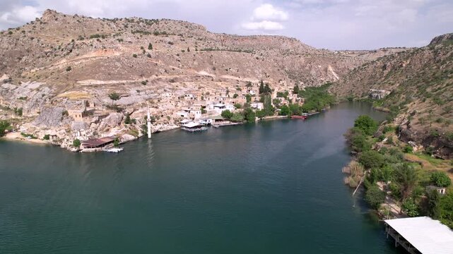 Experience a cinematic flight over the iconic half-submerged minaret of Savaşan Village in Halfeti. This footage highlights the haunting ruins and the turquoise depth of the Euphrates River.