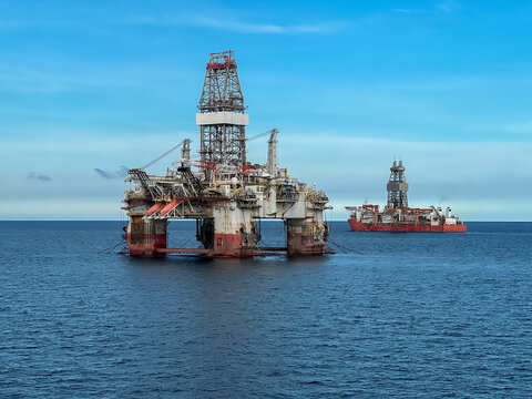 Offshore oil and gas drilling platform, Semi-submersible oil rig, offshore extraction platform and drillship operating in the open ocean during deepwater exploration. Global energy market instability 