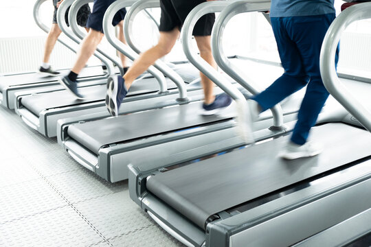 gym shot - people running on machines, treadmill with motion blur