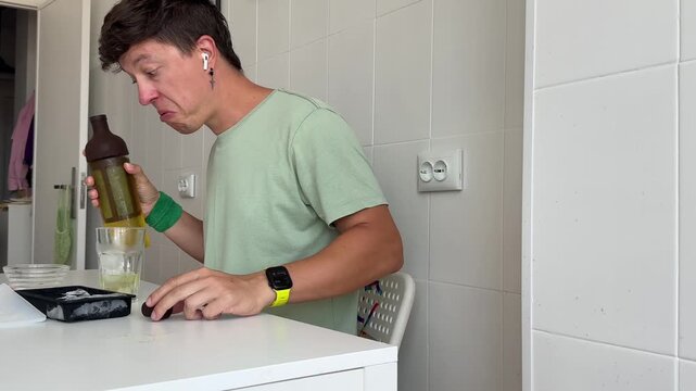 Man cautiously adds drink while avoiding potential mess