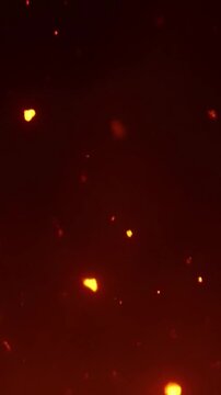 Glowing fire embers floating in dark background