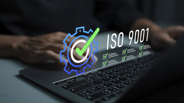ISO 9001 certification concept. Person using laptop with ISO 9001 standard and approval icons, quality management system, compliance verification and business process improvement.