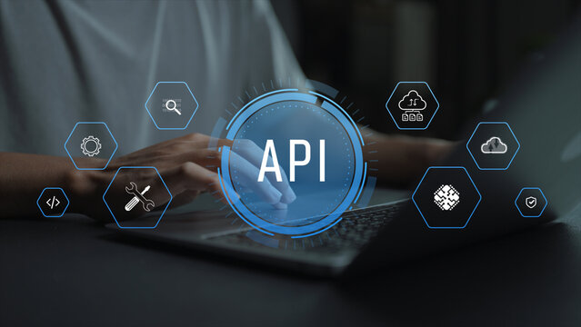 Application programming interface technology concept. Person using laptop with API and cloud connection icons, data exchange, software development and system interoperability.