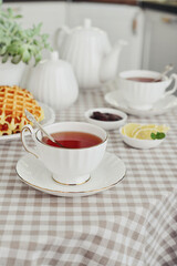 Fototapeta premium breakfast with tea and a homemade Belgian waffles