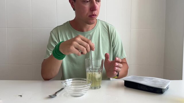 White man pouring concentrate into glass during experiment
