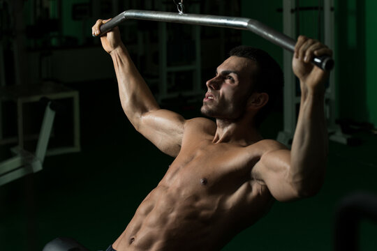 Bodybuilder Doing Heavy Weight Exercise For Back