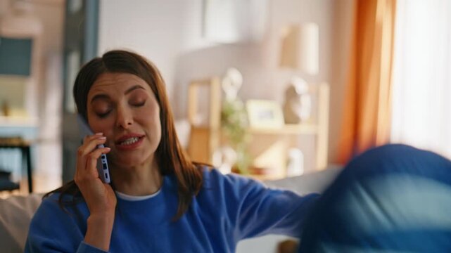Son bothering mother calling cellphone sitting couch closeup. Stressed woman