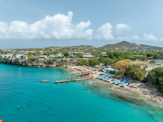 Fototapeta premium Aerial view of Playa Piskado turquoise waters popular snorkeling spot in Curacao