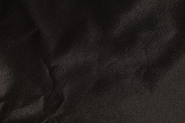 Grossly black crumpled fabric material texture