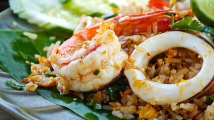 Delicious seafood fried rice served on a plate with fresh garnishes