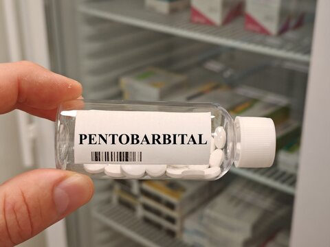 Box of PENTOBARBITAL tablets on a hospital pharmacy table used for sedation and seizures a barbiturate.	
