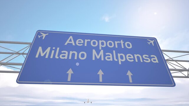 Bright blue motorway indicator toward Milan Malpensa Airport with passenger jet lowering toward the airport, arriving to Milan, Italy.