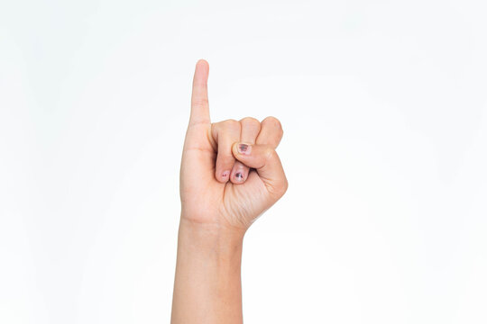 A close-up shot of an Indonesian woman's hand raising the pinky finger, symbolizing a pinky swear or promise, on a white background.
