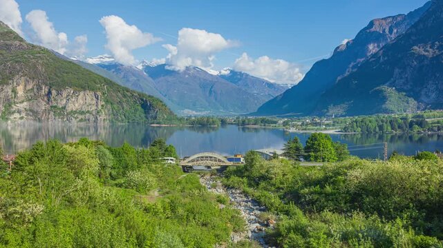 Time lapse, panoramic view on a lake in the mountains. Lake Mezzola near Verceia, Lombardy, Italy.