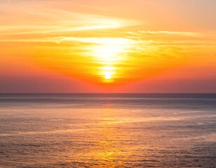 Vibrant Ocean Sunset with Golden Hues and Reflective Waters.
