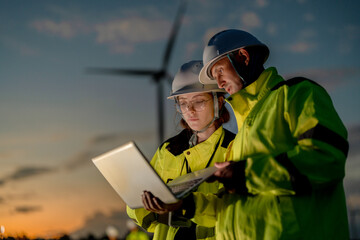 Green collar workforce using advanced tech to manage sustainable wind power. Visionary engineers committed to global ESG goals and carbon neutrality. © ultramansk