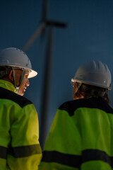 Fototapeta premium Leading the zero emission transition. Environmental specialists coordinating renewable wind turbine operations. Dedicated to sustainable global ESG initiatives.