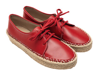 Close-up of two red leather shoes with rope soles and red laces on a dark background