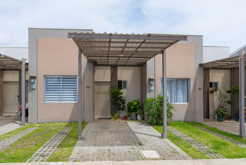 Modern residential townhouse with pergola driveway and plants