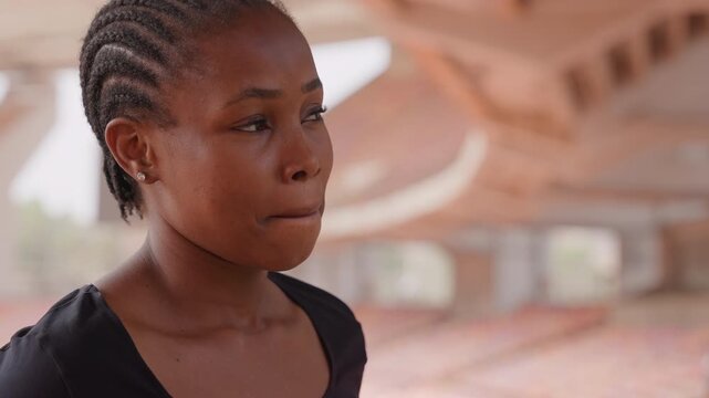 Sprinter focused on upcoming race scene. Athlete poised at starting line ready to leap forward. Determined female sprinter stands at starting point mentally envisioning her swift race