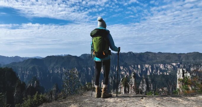 Woman backpacker hiking in the sandstone mountains 