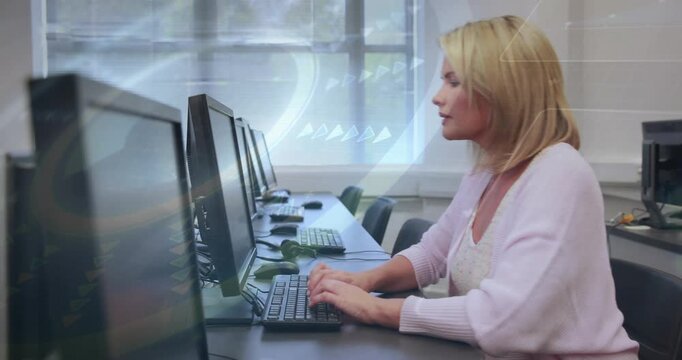 Mature woman typing at lab desk, leaning to read text while circular graphic appearing on monitors