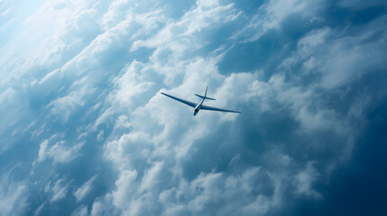 Fototapeta premium Aerial Drone View of Glider Flying Through Blue Cloudy Sky