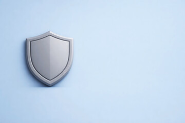 Fototapeta premium Silver shield on light blue background protection