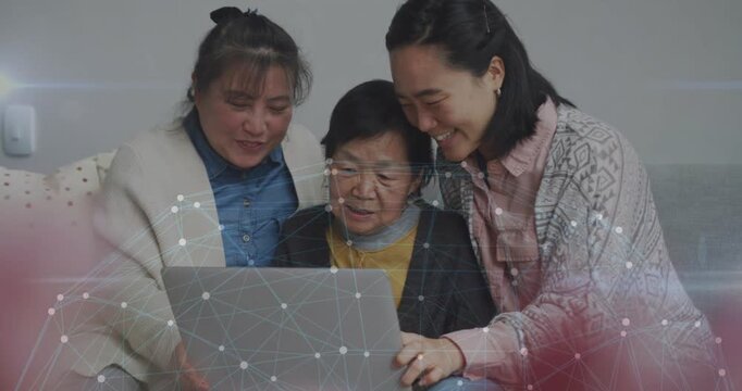 Mother on couch, daughters guiding pointing, senior tapping laptop learning tech as nodes appearing