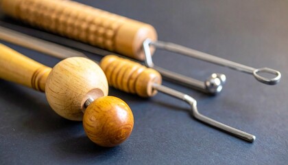 Collection of diverse massage tools in wood, rubber, and metal arranged on dark surface, symbolizing therapy, relaxation, and physical rehabilitation techniques.