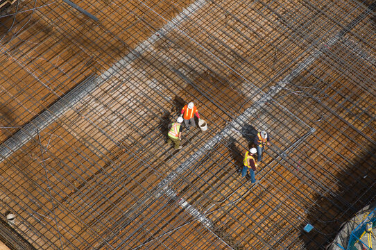 Canada, BC, Vancouver.  Subway rapid transit line construction on Cambie Street using "cut and cover" technique.  Iron workers laying rebar in preparation for concrete pour.