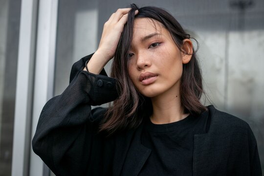 Stylish woman posing confidently outdoors.