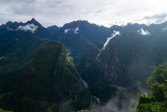 Aguas Calientes Andes Mountains morning Machu Picchu Historic Sanctuary Temple rainy season Inca citadel Eastern Cordillera of southern Peru Incan citadel Peruvian sunrise blue sky low cloud fog