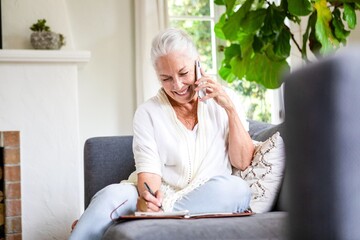 Elderly woman enjoying phone conversation.