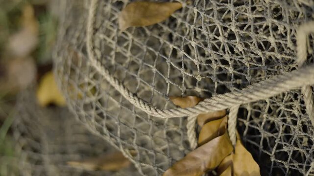 Old Fishing Net Unused Long Time Abandoned Equipment, A poetic photo of an old forgotten fishing net, reflecting the passage of time, perfect for cultural documentary and social awareness.